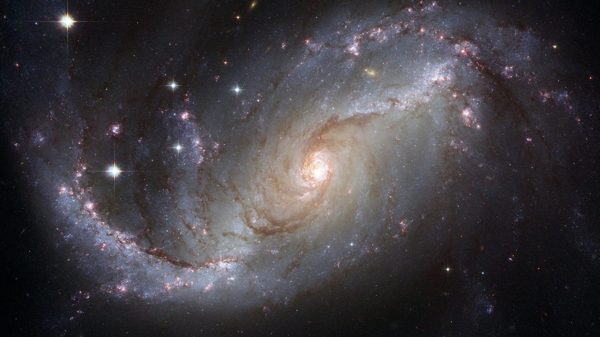 A white spiral arm galaxy upon a starry backdrop